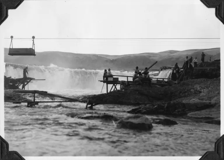 Historic photo of tribal fishers dipnetting for salmon at Celilo Falls on the Columbia River